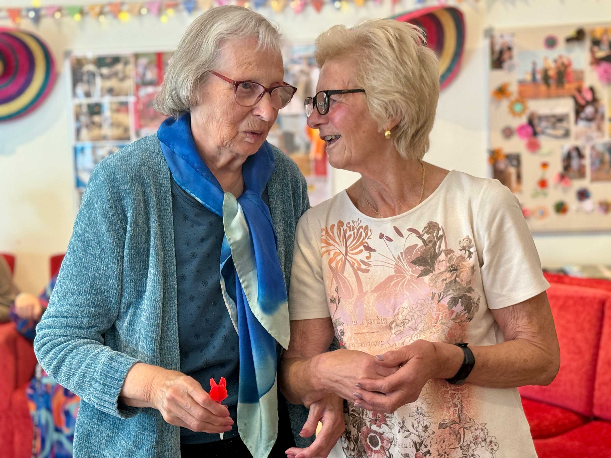 A volunteer and club member share a moment of connection at Mill Street club