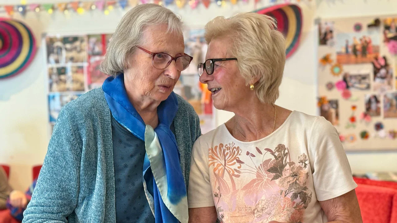 A volunteer and club member share a moment of connection at Mill Street club