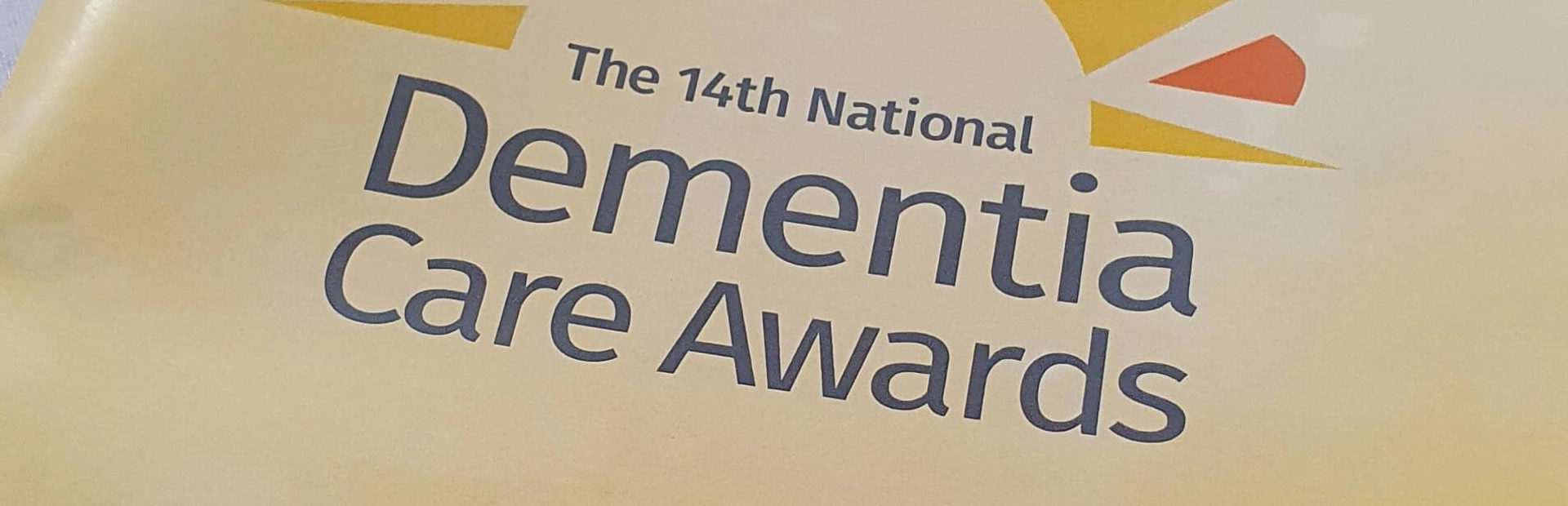 Cover of the programme for the 14th annual Dementia Care awards, showing the organisation and sponsor's logos Cover of the programme for the 14th annual Dementia Care awards, showing the organisation and sponsor's logos