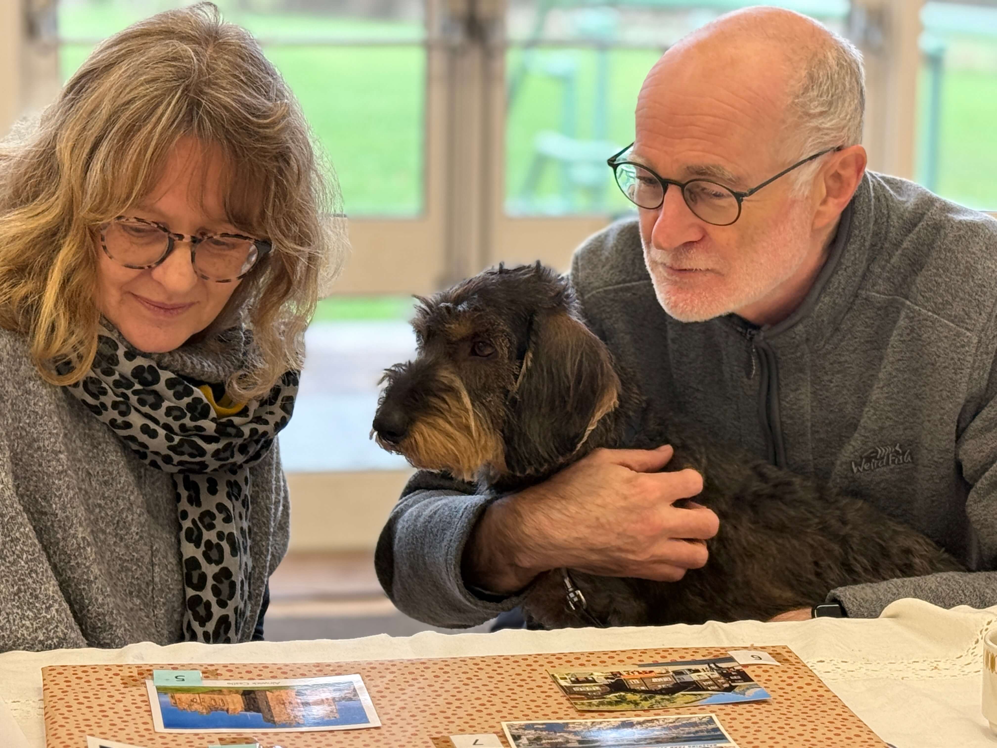 laura and Paul Willis at Kennet Muddy Boots group, playing a quiz with their dog Frankie sitting on Paul's lap.