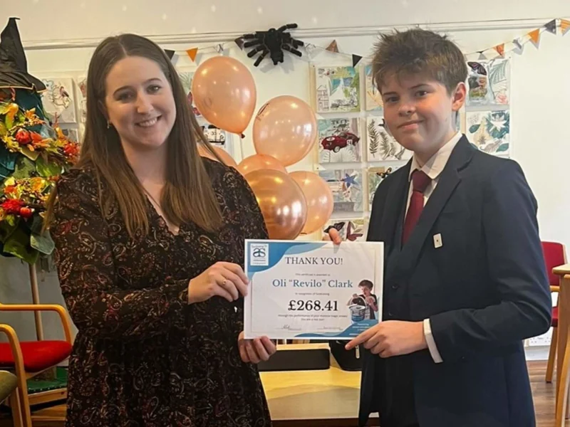 Beyond Dementia staff member Alex presenting an achievement certificate to fundraiser Oli for raising £268.41 Beyond Dementia staff member Alex presenting an achievement certificate to fundraiser Oli for raising £268.41