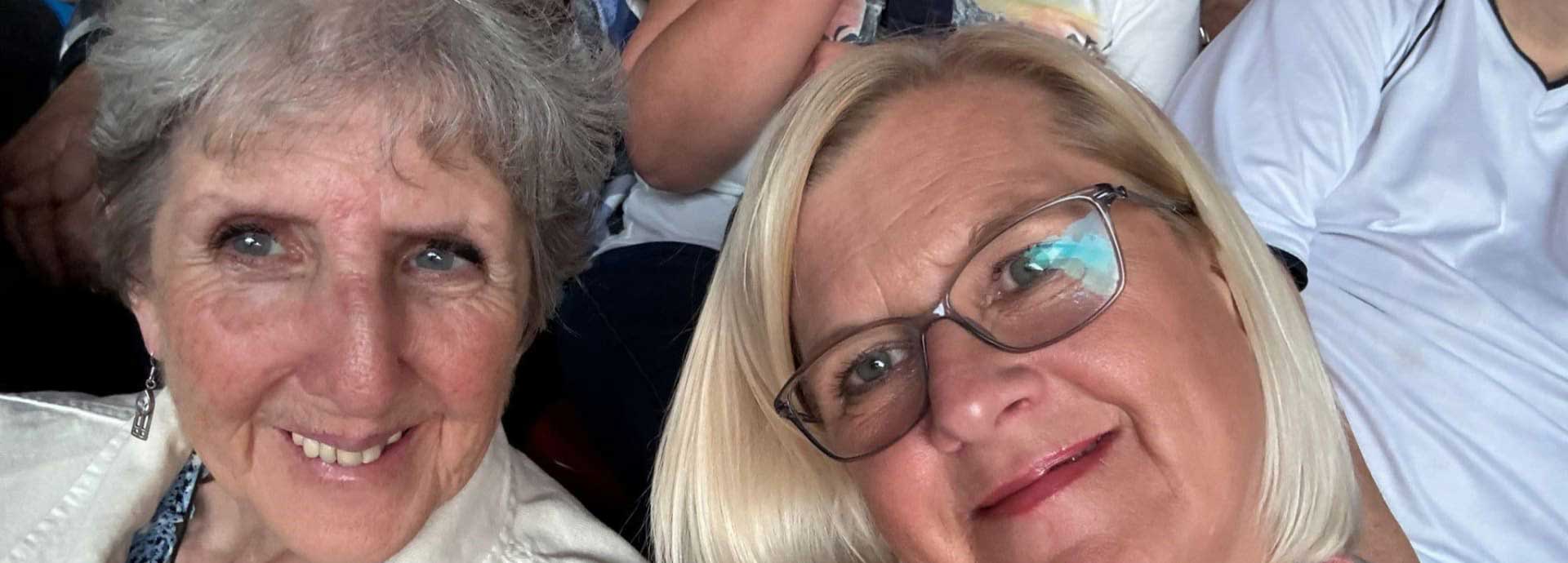 A close up picture showing Sandra and Gemma sitting next to each other, smiling for a selfie