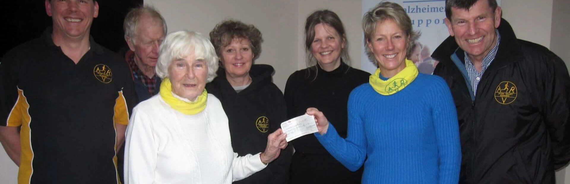 A group of seven people from Avon Valley Runners holding a cheque donation from Sheila the organiser A group of seven people from Avon Valley Runners holding a cheque donation from Sheila the organiser