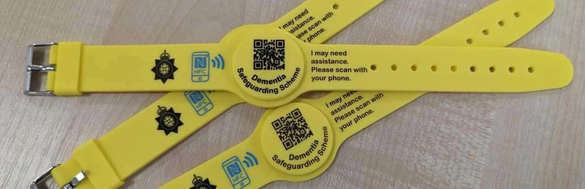 Three yellow wristbands grouped together on a table Three yellow wristbands grouped together on a table